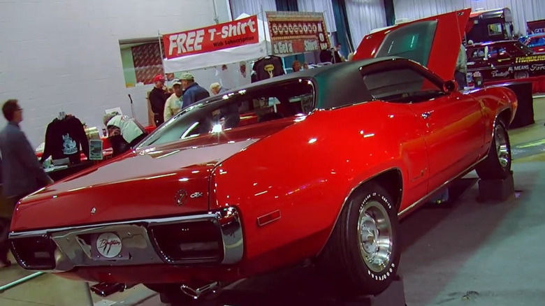 A red 1972 Road Runner V-code muscle car with a 440 V8 at a car show