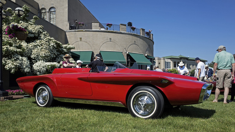 A 1960 Plymouth XNR concept car on grass at an event