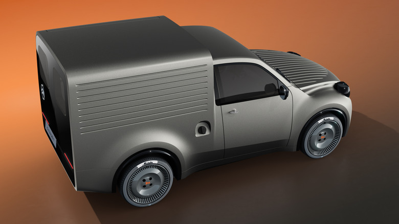 Rear 3/4 view of a silver Citroën 2CV Fourgonnette Concept against an orange background