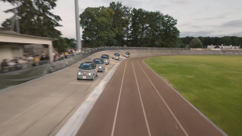 A line of Citroën Amis circling the Commentry Velodrome