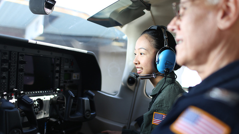 A Civil Air Patrol cadet and instructor review the instrumentation in a cockpit.
