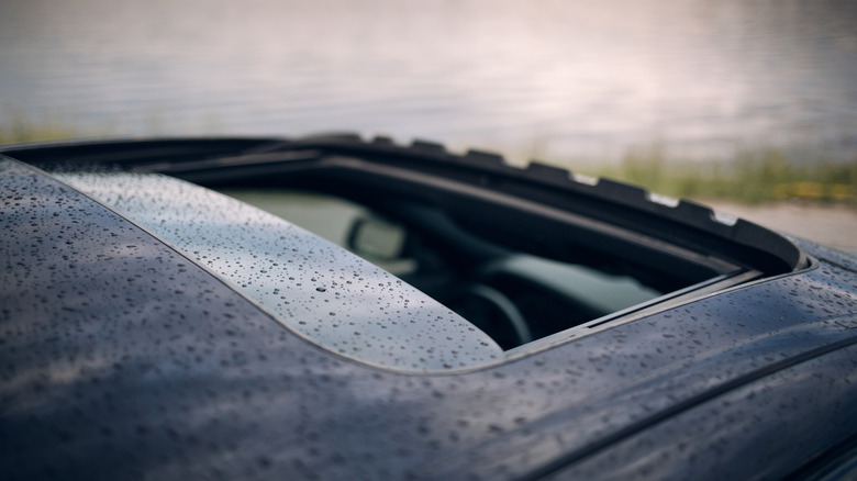 An open car sunroof in the rain