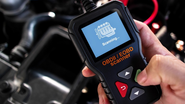 Hand holding OBDII scanner