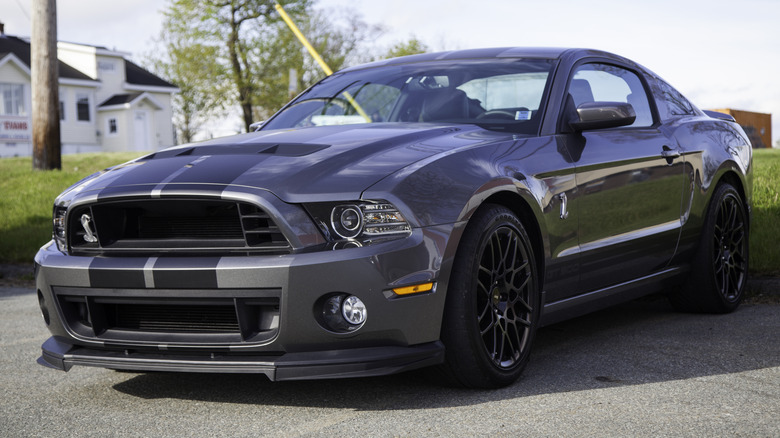 A dark blue Ford Shelby GT500 in a parking lot.