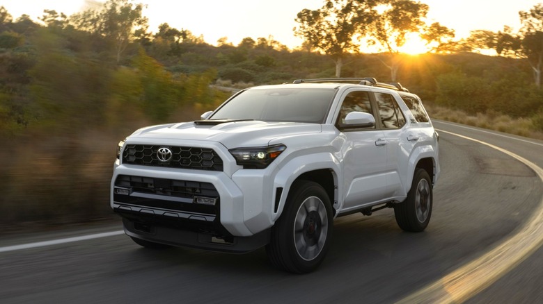 A white Toyota 4Runner driving on the road.