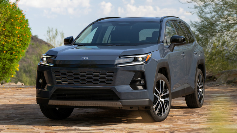 2026 gray Toyota RAV4 with lots of foliage in the background