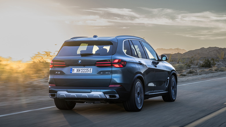 A 2024 BMW X5 driving on a road