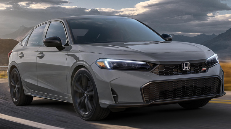 A gray 2025 Honda Civic Si driving on a winding country road