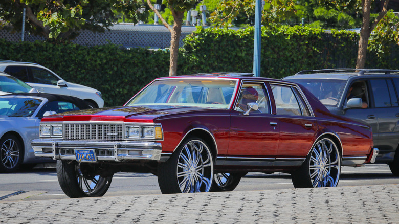 A Chevy rolls around on massive wheels, known as donks.