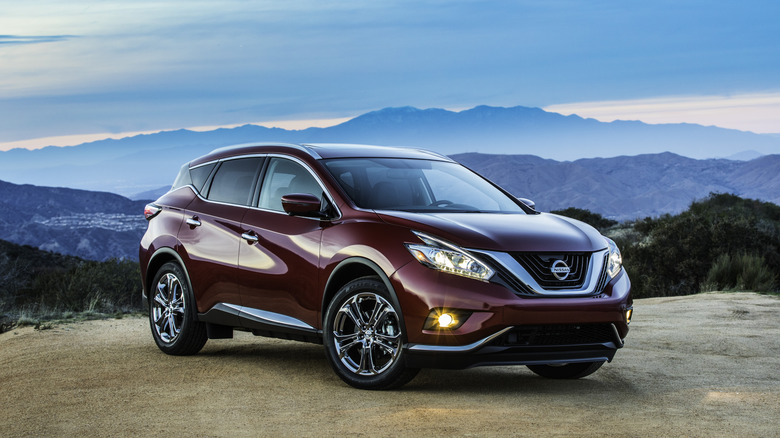 A front 3/4 shot of a wine-colored 2018 Nissan Murano parked with mountains in the background