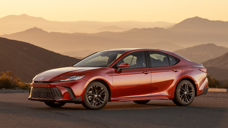 A red 2026 Toyota Camry on top of a hill.