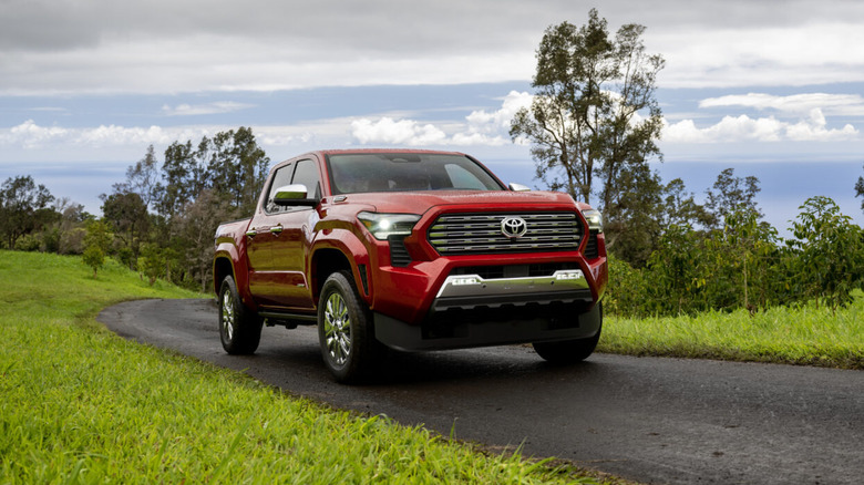 A red 2026 Toyota Tacoma on a paved roadway.