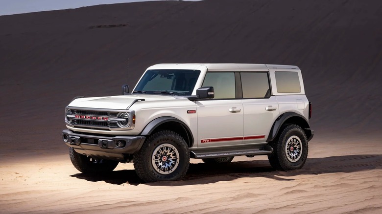Front 3/4 of a white 2026 Ford Bronco 60th Anniversary Package on sand