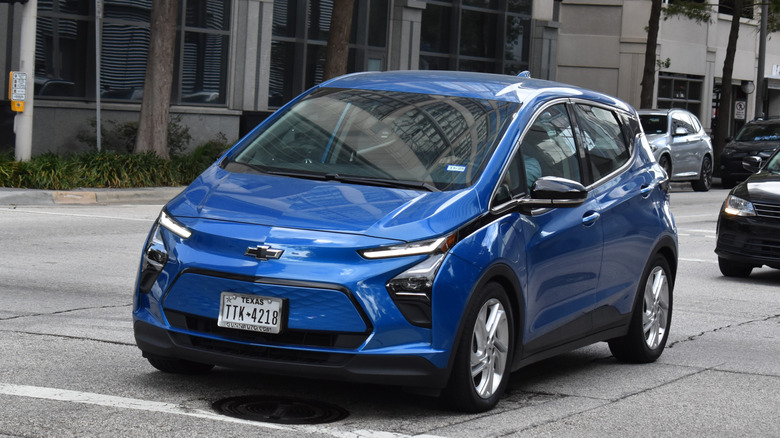 A 2023 Chevy Bolt moves through urban traffic.