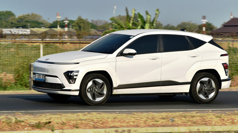 A Hyundai Kona EV on a narrow road.