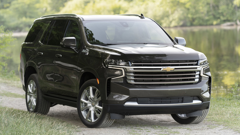 A black 2021 Chevrolet Tahoe on an unpaved trail.