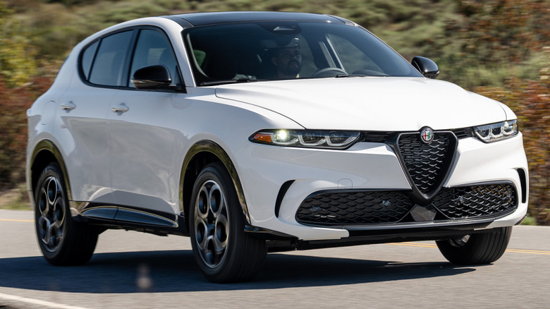 2025 Alfa Romeo Tonale driving on a road through hills
