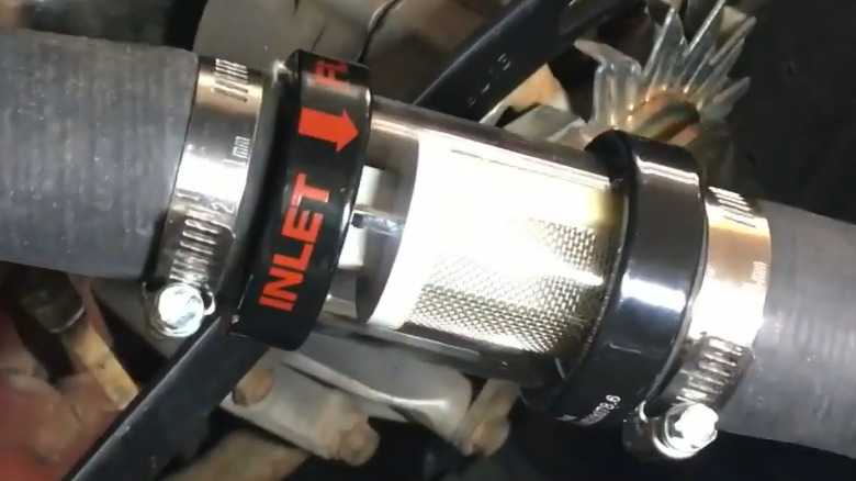 An inline coolant filter fitted to a car's coolant system