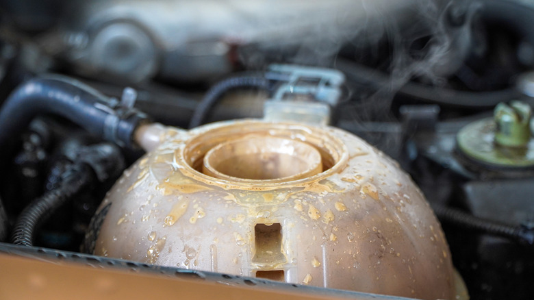 A dirty coolant reservoir with milky coolant residue on the outside