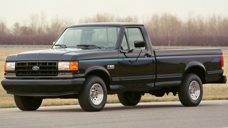 A Ford F-150 Night sits on the road with a cloudy background.