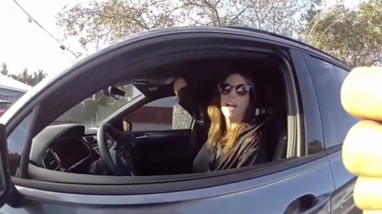 A woman shows a police officer she doesn't have a right hand as she's being ticketed for driving with a phone in her right hand