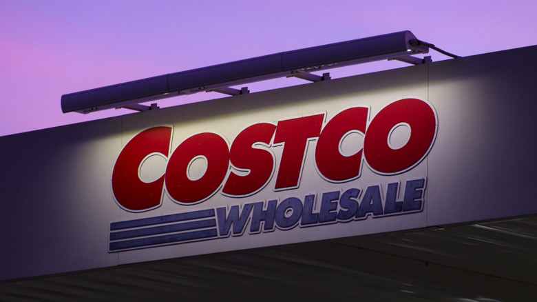 A Costco Wholesale sign at dusk.