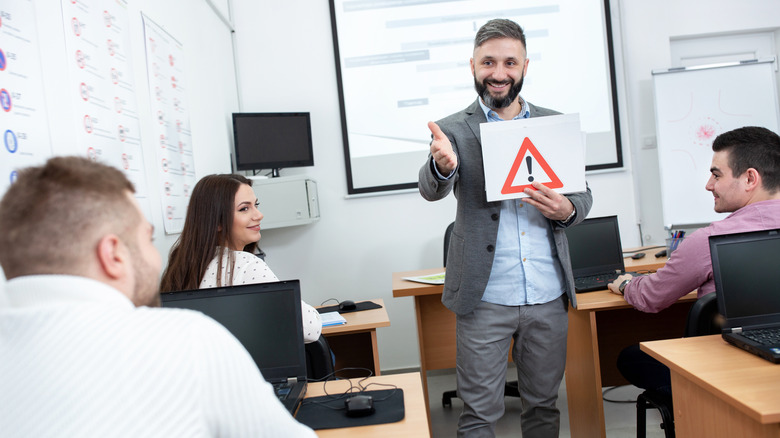 Instructor teaching students about traffic signs