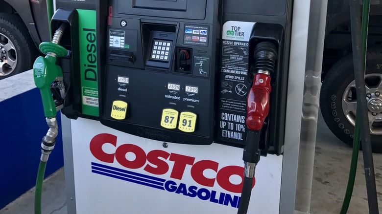 A Costco station shown with green diesel and red gasoline fuel pumps.