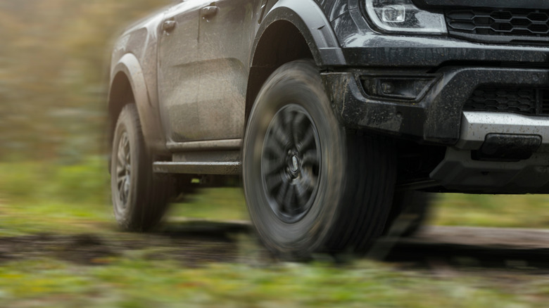 A black pickup truck with all-terrain tires