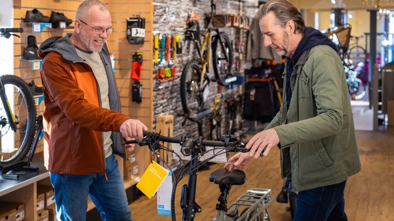 Two customers looking at an e-bike at a bike shop
