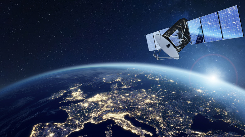 Artist's rendering of a satellite over Europe lit by city lights