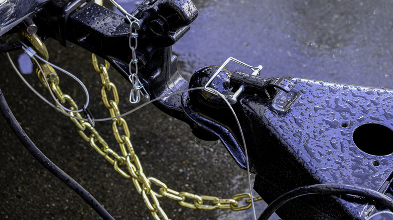 A set of plated trailer chains in a cross pattern