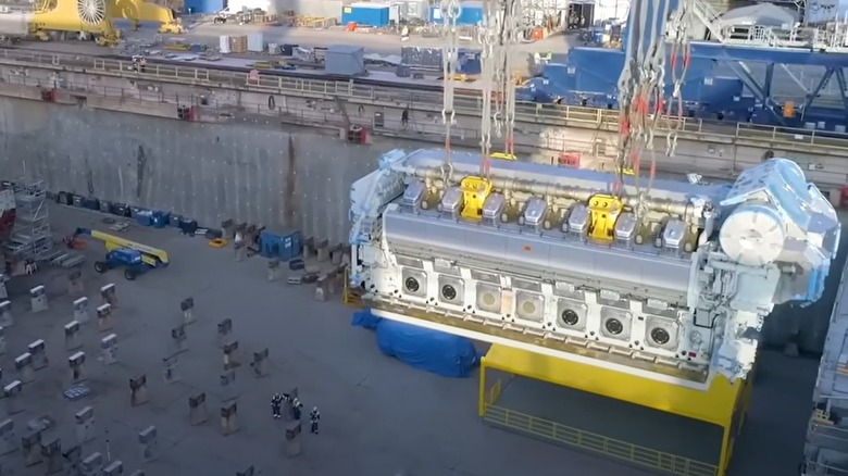 14-cylinder Wärtsilä engine being lowered by cranes into the future engine room of the Icon of the Seas