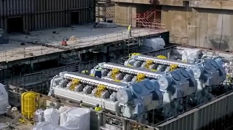 Three 14-cylinder Wärtsilä engines being installed during the construction of the Icon of the Seas