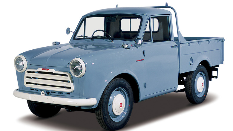 Front-quarter shot of a 1958 Datsun 220 Pickup truck in a studio setting