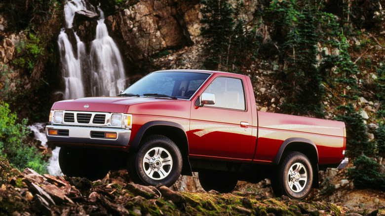 Front-quarter shot of a 1997 Nissan Frontier parked on scenic trail