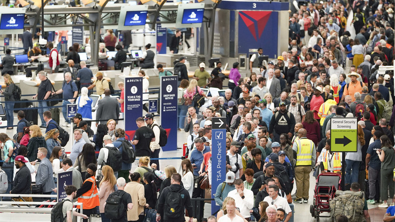 Travelers stand in long lines at Atlanta Hartsfield-Jackson International Airport on March 23, 2026 in Atlanta, Georgia.