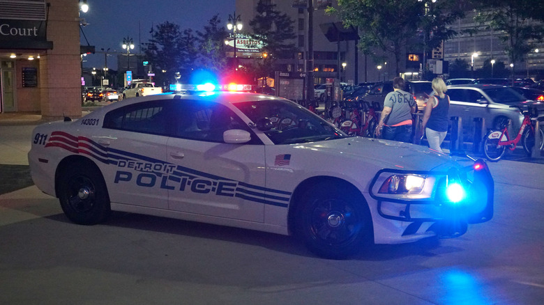 Side view of a Detroit Police Dodge Charger at night with its lights on