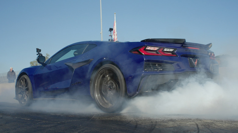 A blue 2026 Chevrolet Corvette ZR1X with smoking tires as it peels out on a quarter-mile drag strip run.