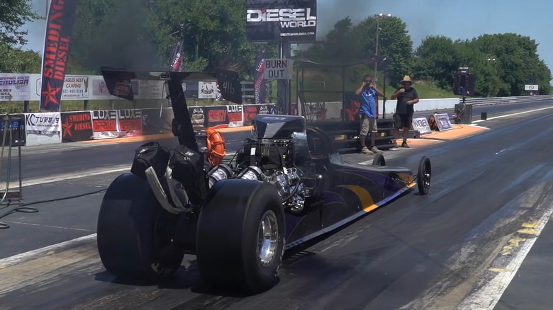 Rear view of a diesel dragster launching
