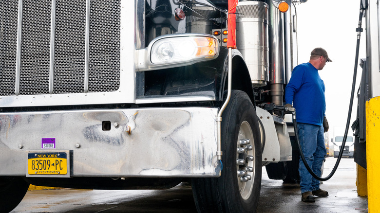 Front view of a trucker fueling up his semi at a truck stop