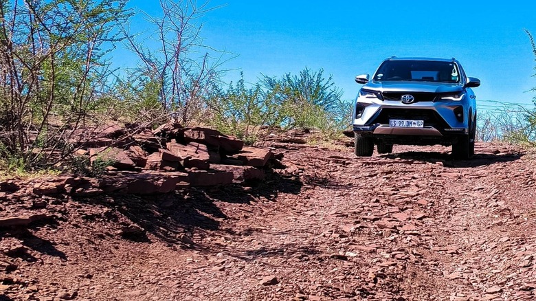 Toyota vehicle off roading on a very technical trail
