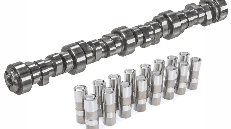 A roller camshaft with its accompanying roller tappets, note the cam's rounded lobes and tappets' roller wheels.