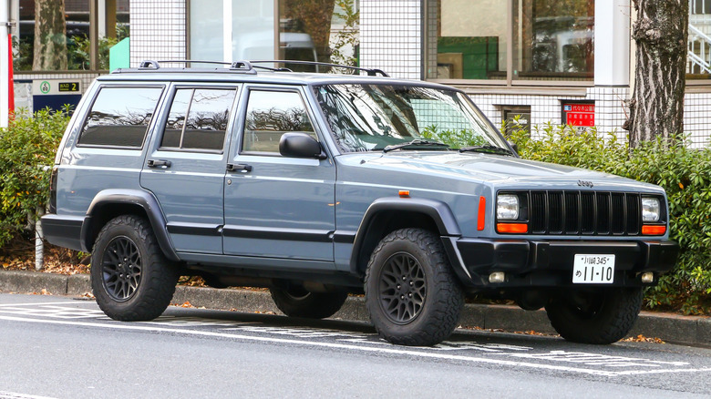 A blue Jeep Cherokee XJ parked on the street