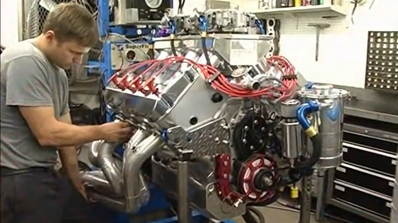 A man works on Sonny's Racing's SAR 1005 V8 engine