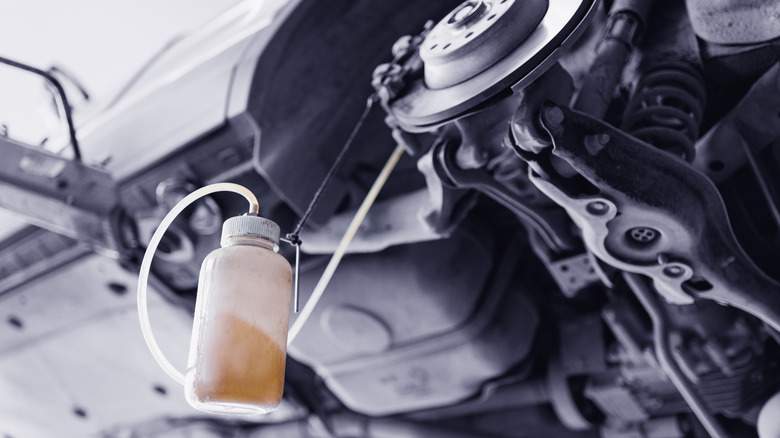 Close up image of a brake fluid reservoir from a brake bleed kit.