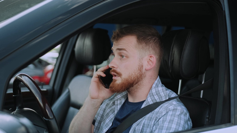 Man sitting in his car making a phone call
