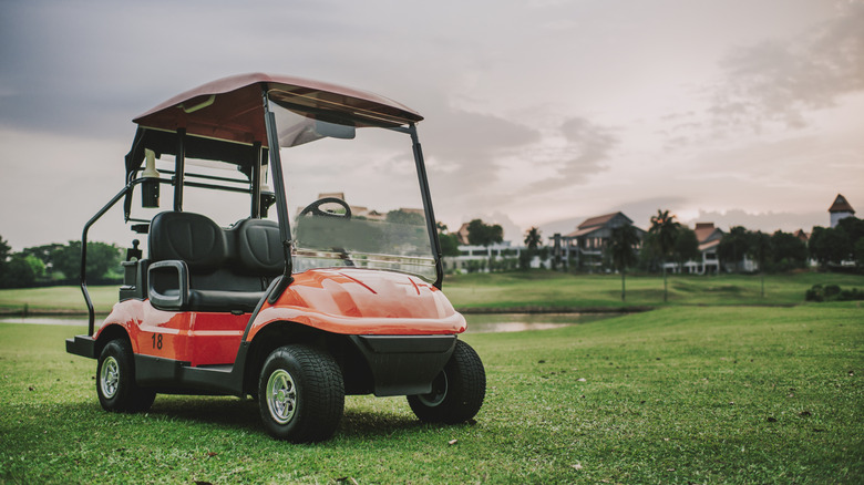 A red golf cart in the golf course
