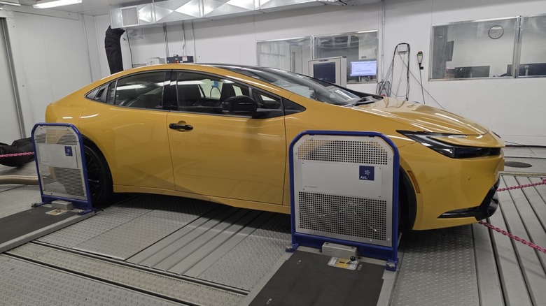 A yellow 2026 Toyota Prius on AAA's test dynamometer.
