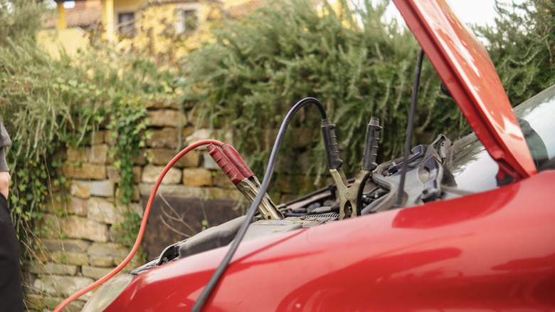 Jumper cables connected to car battery